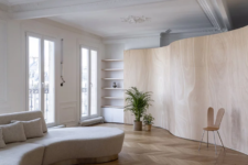 01 This typical Hausmann apartment in Paris got a renovation and redesign with a curved wooden space divider that doubles as an artwork