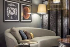 02 a catchy living room with a retro feel and a curved taupe sofa, a bold gallery wall and gold wire pendant lamps