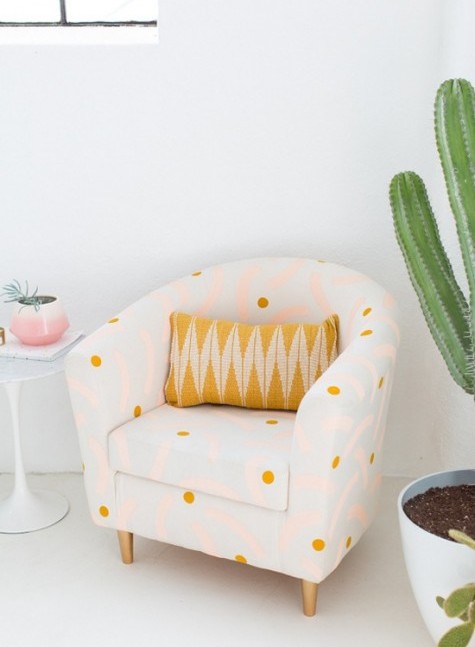 an IKEA Tullsta chair renovation with polka dots and bright pink patterns and finished with a printed crochet pillow