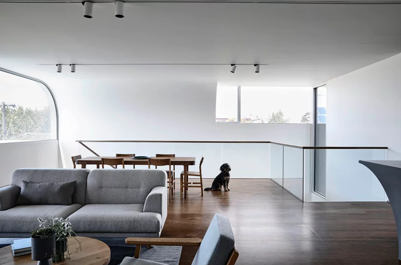 The main living space is an open plan raised up to enjoy the views of the neighborhood