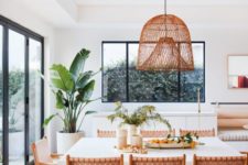 03 a Californian kitchen with a woven lamp, woven leather chairs and a large scale plant