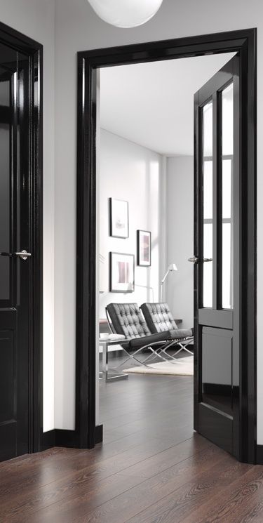 glossy black doors add catchiness and a slight shine to the neutral and monochromatic spaces like these ones