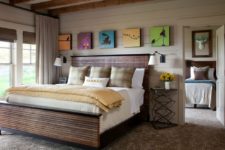 05 The bedroom is done with a wood slate bed, colorful artworks, metal side tables