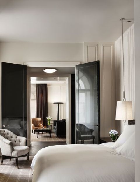 Refined neutral interiors spruced up with dark touches   rich browns and black, glossy black doors are a bold statement