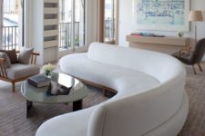 06 a gorgeous curved white sofa takes over the whole living room and adds soft lines and shapes to it