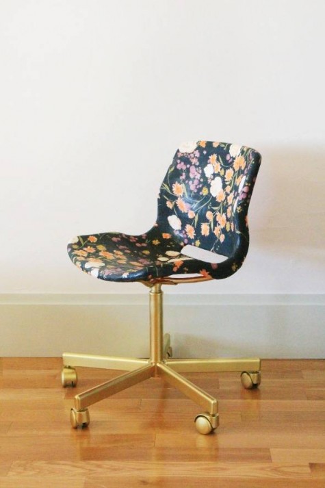 a basic IKEA office chair reupholstered with moody floral fabric and gold spray pinted base and legs