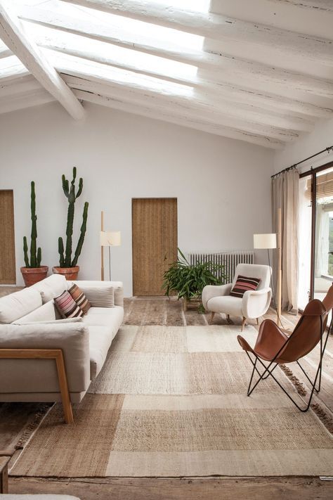 a natural color palette, some statement cacti in pots and natural light coming through skylights make the space cooler