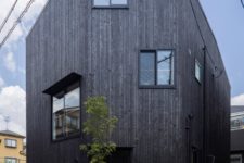 09 The exterior of the house is clad with blackened wood, and you can see how irregular windows are positioned