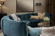09 a moody refined living room with a curved teal sofa that adds color to the space and makes it bolder