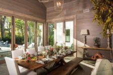 10 The dining room is clad with dark wood, stained dining set and glazed walls