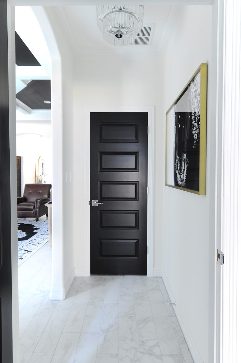 a simple builder grade door can become a real stylish piece if you just paint it matte black like here