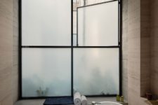 13 The bathroom is done with a frosted glass window, an oval tub and simple yet luxurious items