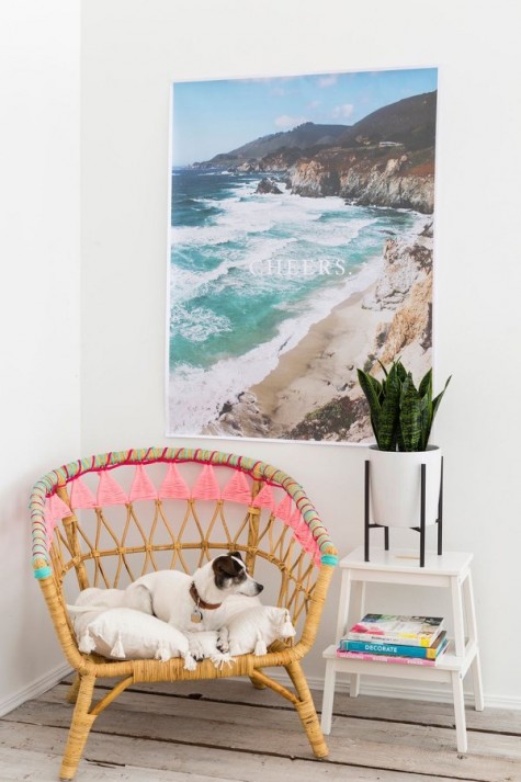 an IKEA Rattan chair hacked with colorful yarn and tassels is a veyr easy and fast craft that will give your chair for a boho feel