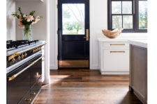 20 a chic kitchen with a touch of art deco – a black and gold cooker and a matching door and black frame windows