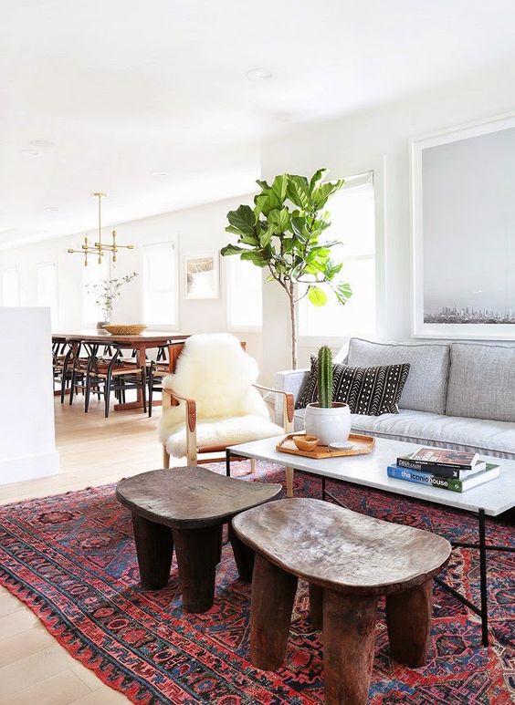 Layering, bold prints and natural materials plus mid century modern furniture make this home feel Californian