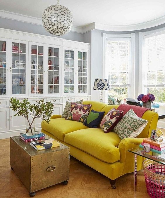 a bold mustard velvet sofa is the main decor piece in this space, and it brings color to it