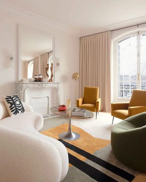 a Parisian chic living room with a non-working fireplace, a curved white boucle sofa, mustard and green chairs, a coffee table and a mirror over the mantel