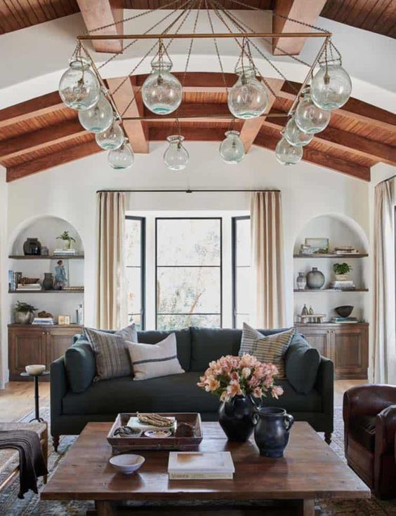 a living room with exposed wooden beams always looks cozy
