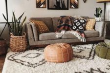 a boho living room done in earthy colors and shades with printed textiles, throws, tribal artworks