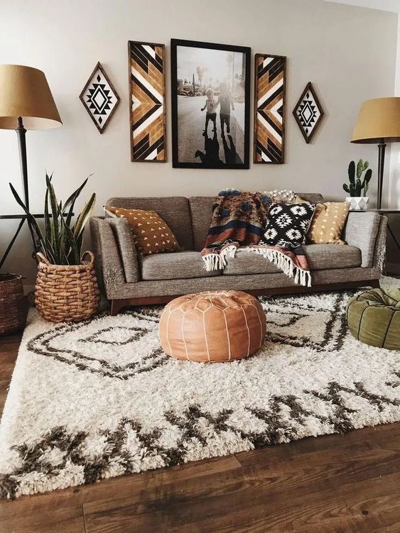a boho living room done in earthy colors and shades with printed textiles, throws, tribal artworks