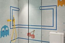 a bright and fun kids’ bathroom with mosaic tiles and fun patterns, a seamless shower space
