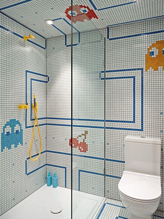 a bright and fun kids' bathroom with mosaic tiles and fun patterns, a seamless shower space