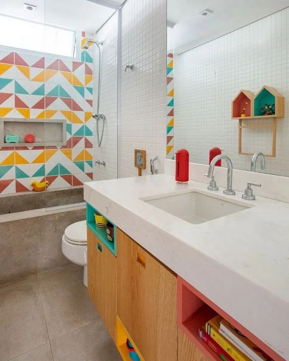 a bright modern kids' bathroom with a colorful tile wall, bright niches and a concrete bathroom is a fresh idea