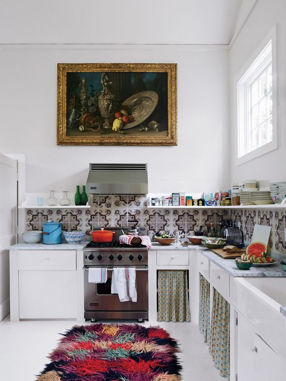 a colorful fluffy rug, a mosaic tile backsplash and some curtains give this kitchen a cool boho feel