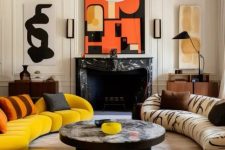 a contrasting living room with a black marble fireplace, two curved sofas and poufs, a round coffee table and bold modernist art