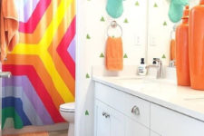 a faux turquoise deer head, colorful towels and a super bright shower curtain will turn a simple bathroom into a kids’ one
