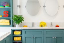a turquoise and white bathroom with white appliances and countertops and lots of colorful accessories that make the space bold