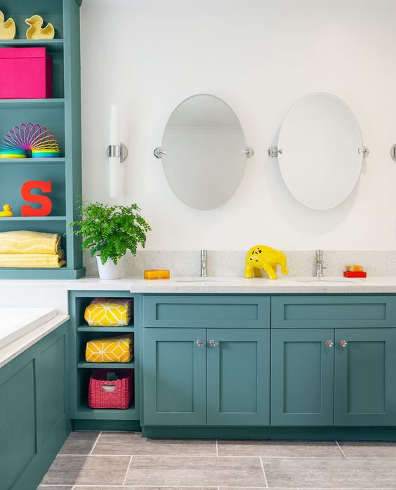 a turquoise and white bathroom with white appliances and countertops and lots of colorful accessories that make the space bold