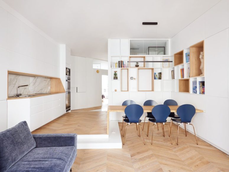 This bold Paris apartment features contemporary style, Paris chic and touches of light colored wood and blue here and there