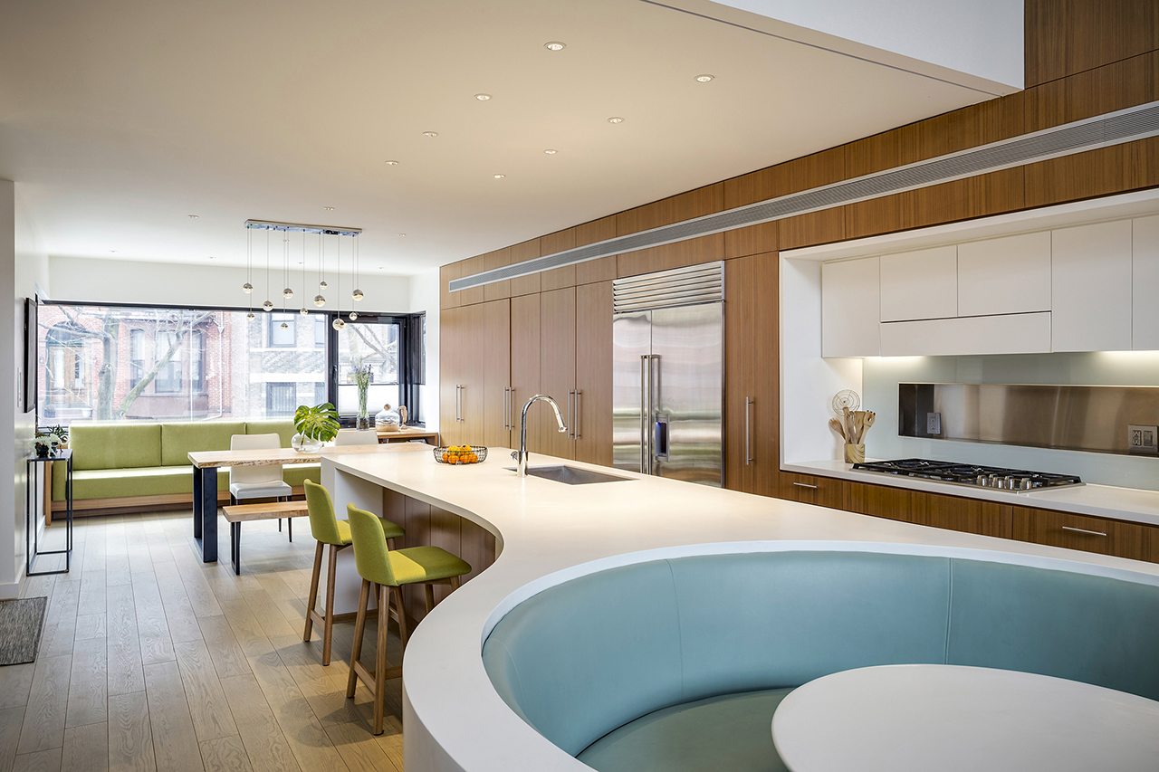 The kitchen features a large kitchen island with a breakfast space and a sunken seating space