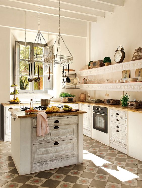 a beautiful white kitchen with a vintage-inspired whitewashed kitchen island for a trendy look