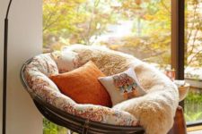 02 a cool papasan chair of dark sturdy wood, with a colorful futon and pillows to form a cozy reading nook by the window
