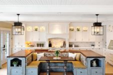 02 a farmhouse kitchen done in white with a blue kitchen island that includes storage and a seating area