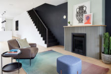 03 The living room is represented with a grene fireplace, comfy mid-century modenr furniture and a gradient rug