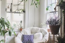04 a chic nook with lots of potted plants and a papasan chair of rattan, with a neutral futon and bright pillows