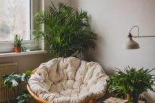05 a cozy reading nook with a papasan chair with a neutral futon and lots of potted greenery