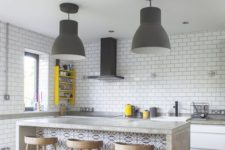 05 an ultra-modern kitchen done with white subway tiles, a concrete kitchen island with a seating space for dining here