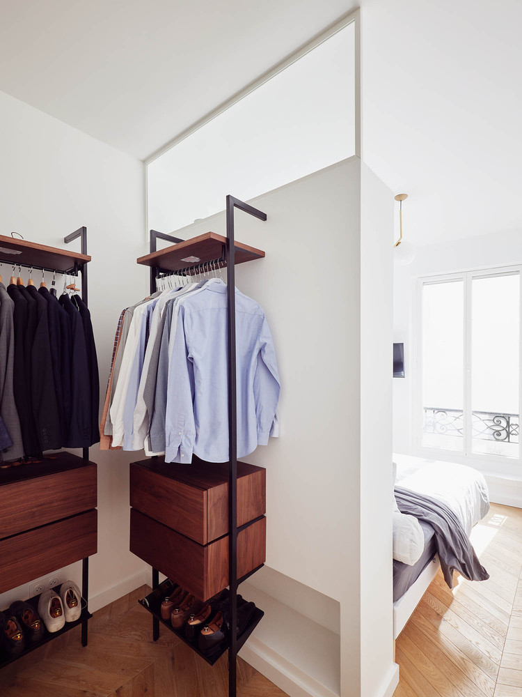 One of the bedrooms features a small yet well-organized and comfortable closet