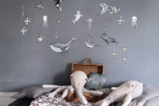 06 a grey nursery with a sea creature statement wall and some cute sea life plush toys