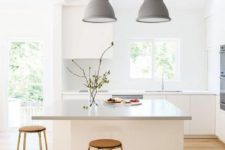 07 a light-filled Scandinavian kitchen with a large kitchen island that features a longer countertop for comfortable eating here
