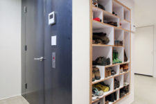 08 The mudroom features a creative shoe storage unit built into the wall