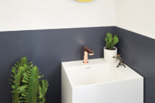 08 The powder room features color blocking, potted cacti and a floating sink with storage