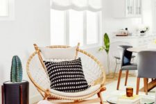 09 a papasan chair styled in a boho way, with macrame and monochromatic pillows for a boho space