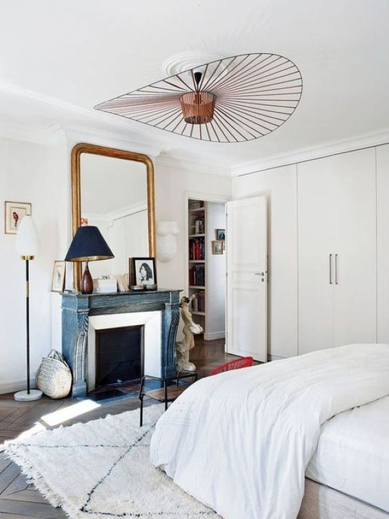 a romantic Parisian bedroom with a statement copper chandelier of a geometric shape is wow