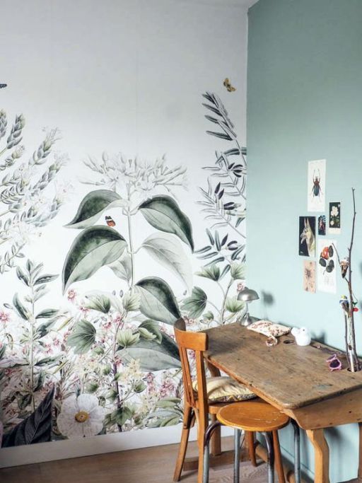 a chic working space or crafting nook with a botanical wallpaper wall and a matching light green one