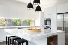 10 a contemporary kitchen done in white, with an oversized kitchen island that features storage and a countertop for eating at the same time